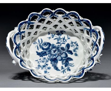 A Worcester basket, c1780, of oval open trellis form with twig handles issuing from applied flowers, painted and transfer pri