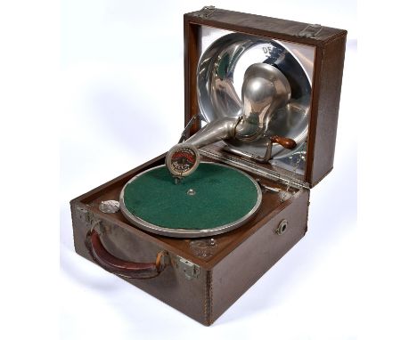 A Decca portable gramophone, with nickel plated reflector and maker’s sound box, in fabric covered case with leather handle a