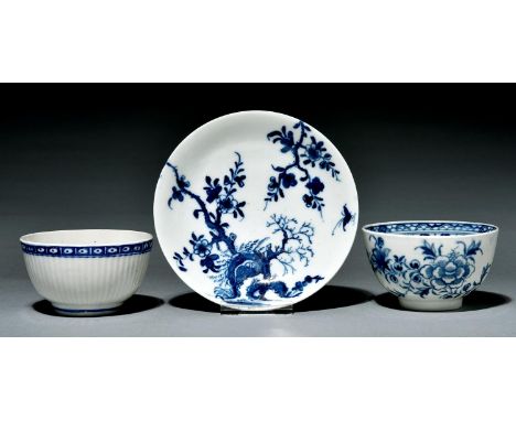 A Worcester saucer and two tea bowls, c1770, painted in underglaze blue with the Prunus Root, Peony or Printed Diaper Border 