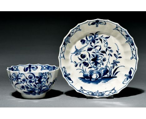A Worcester fluted tea bowl and saucer, c1770, painted in underglaze blue with the Hollow Rock Lily pattern, saucer 12cm diam