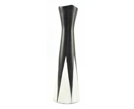 A Modernist vintage 20th century black and white two tone ceramic vase. The vase modeled a floral shaped mouth rim with a tap