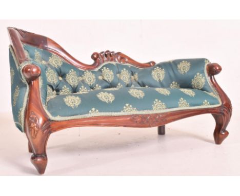 An early 20th century apprentice piece mahogany upholstered chaise longue settee daybed. The settee featuring scrolling mahog