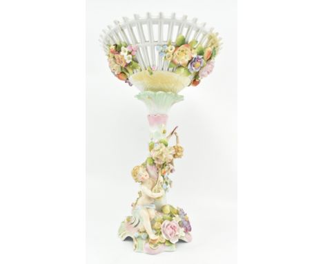 An early 20th century floral encrusted porcelain fruit bowl centrepiece. The centrepiece with pierced conical bowl featuring 