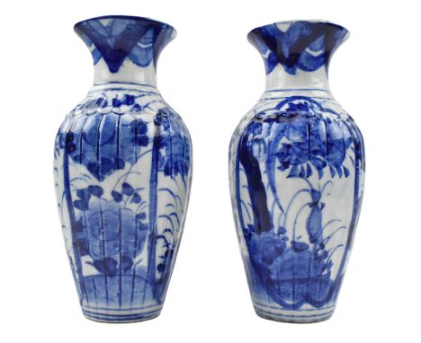 A pair of 20th century Japanese Arita style blue and white ceramic vases. Each baluster shaped vase decorated with flowers, l