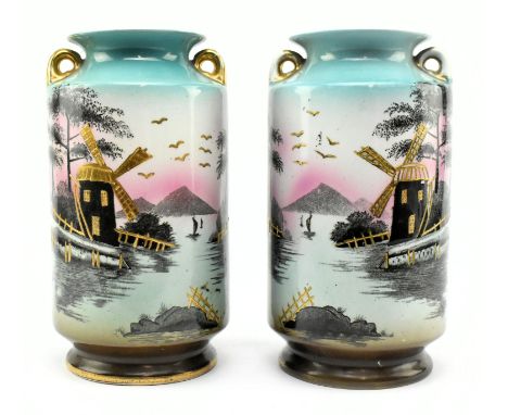 A pair of 20th century Cameo Ware twin handled ceramic vases. Each twin gilt handled vase decorated with a scene of a riversi