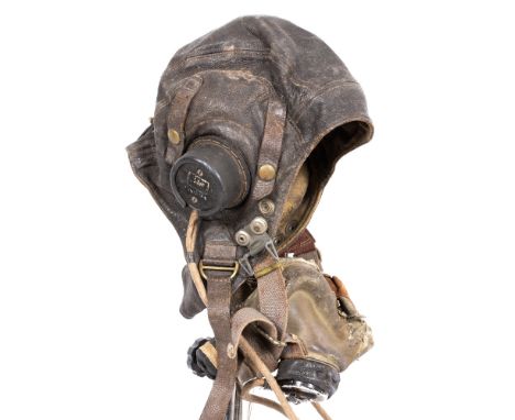 A WWII AIR MINISTRY FLYING HELMET with indistinct serial number, purportedly once belonging to a Pilot who flew Lancaster Bom