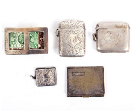 TWO SILVER VESTA CASES  with engraved decoration, a silver miniature stamp envelope, one other stamp holder and a desk stamp 