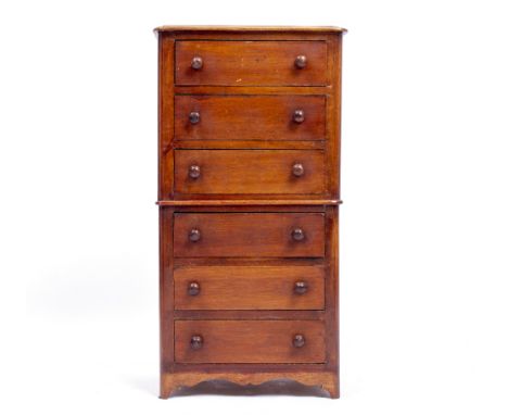 A MINIATURE MAHOGANY CHEST OF TALL DRAWERS consisting of six long drawers with turned handles, standing on bracket feet, 26.5