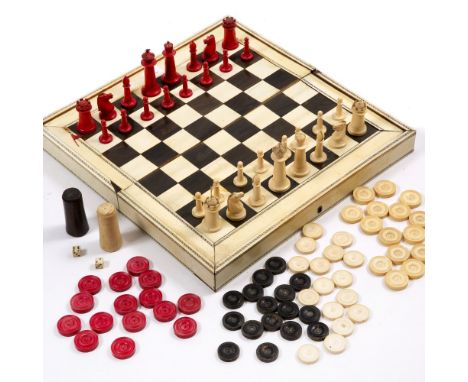 A 19TH CENTURY VIZAGAPATAM ANGLO INDIAN IVORY AND EBONY CHESS and backgammon set with a sandalwood interior, stained ivory ga