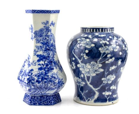 A 19TH CENTURY CHINESE BLUE AND WHITE BALUSTER VASE decorated with prunus blossom, with a Kangxi mark to the base, 23cm high 