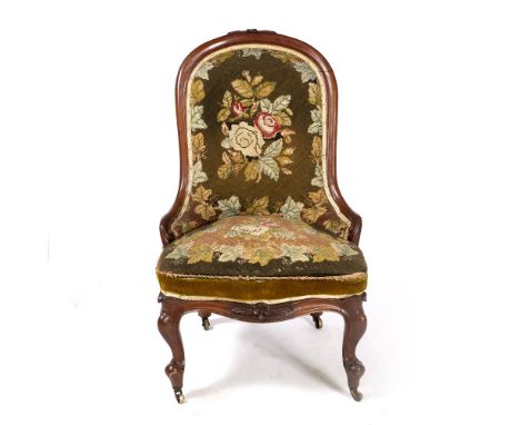 A VICTORIAN TAPESTRY UPHOLSTERED LOW CHAIR with cabriole legs and brass castors 58cm wide x 60cm deep x 94cm high 