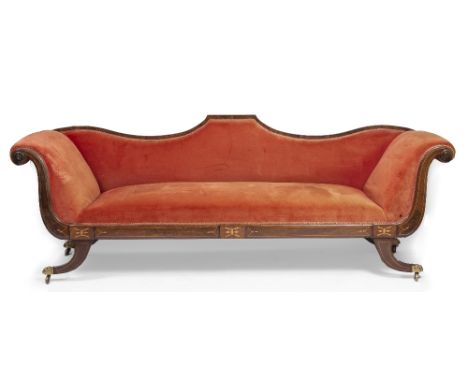 A REGENCY MAHOGANY FRAMED SOFA with shaped back, scroll ends and sabre legs terminating in hairy paw feet and casters, 240cm 