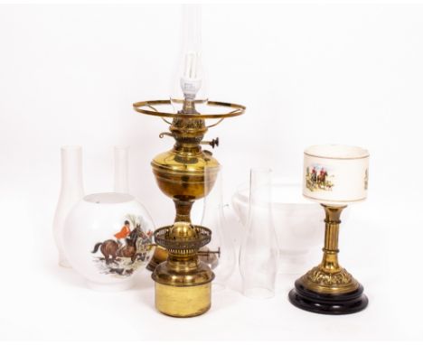 TWO VINTAGE OIL LAMPS (one converted) and three spare glass chimneys (a quantity)