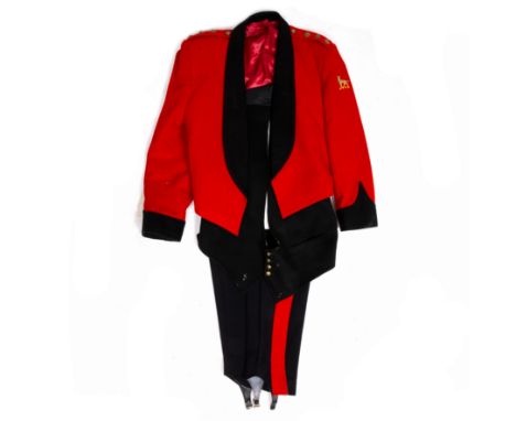 A MILITARY REGIMENTAL DRESS UNIFORM or mess kit, a red jacket with black trim, waistcoat and matching trousers, wtih gold emb