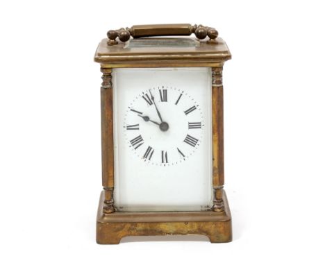 A LATE 19TH / EARLY 20TH CENTURY BRONZE CASED CARRIAGE CLOCK with white enamel dial and black Roman numerals, with key and sw