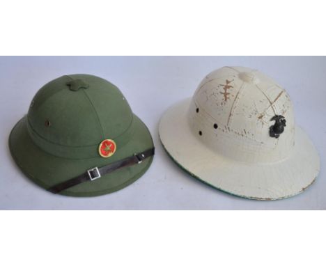 A 1960s era US Marines tropical Pith helmet with sweat band, no other markings, with USMC cap badge, and a modern reproductio