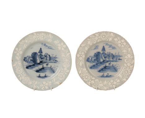 A PAIR OF BRISTOL DELFTWARE PLATES circa 1760, decorated with an Oriental fishing scene, with a bianco-sopra-bianco border wi