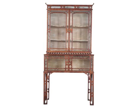 A MID-VICTORIAN WALNUT DISPLAY CABINET-ON-STAND mid-19th century, of George II style, the rectangular top with scrolled corne