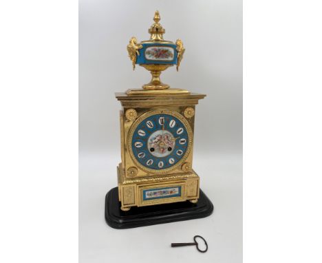 A GILT METAL AND PORCELAIN MOUNTED MANTEL CLOCK Of LOUIS XVI STYLE the porcelain dial painted with cherubs, the case-stamped 