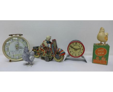 A tin plated clockwork motorcycle with clown, made in Gt. Britain, a tortoise and hare alarm clock, two Roddy egg laying hen 