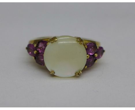 A silver gilt, mother of pearl and garnet ring, L