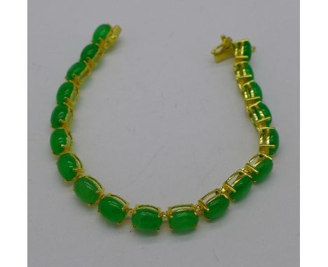 A silver gilt and jade bracelet