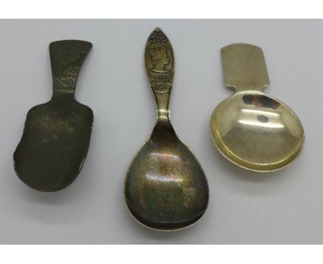 A silver caddy spoon and two other caddy spoons
