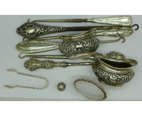 A collection of silver including a thimble, a pair of silver salts, an .800 napkin ring, button hooks, etc.