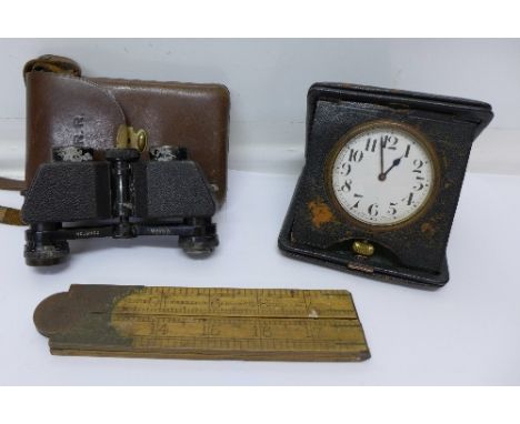 A Swiss made travel alarm clock, a ruler and a pair of Carl Zeiss binoculars with leather case