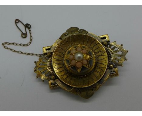A yellow metal brooch set with coral and seed pearl, 10g, with one loose coral bead