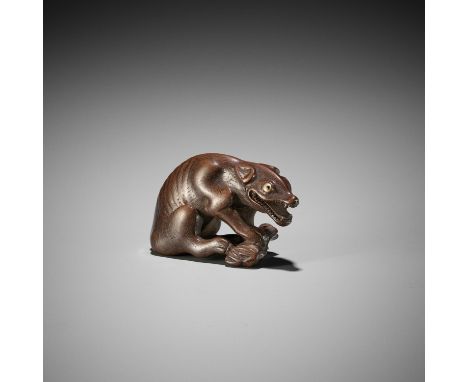 A FINE WOOD NETSUKE OF A WOLF WITH HAUNCH OF VENISONUnsignedJapan, probably Kyoto, late 18th to early 19th century, Edo perio