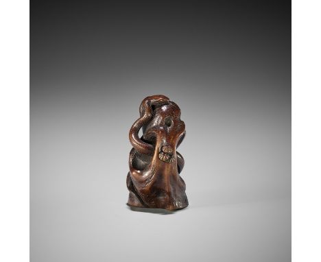 SUKEYUKI: A FINE WOOD OKIMONO OF A SNAKE WINDING THROUGH A ROCKBy Sukeyuki, signed Sentei Sukeyuki zoJapan, Hida province, Ta
