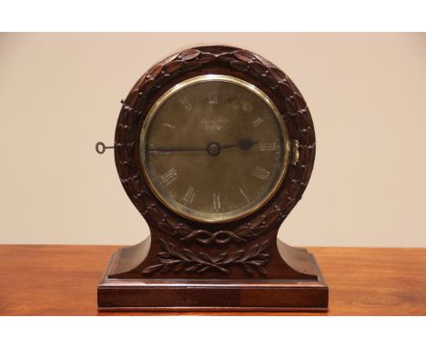 A 19th century double sided mahogany library/table clock by Simeon Shole Deptford, the balloon shaped clock case with carved 