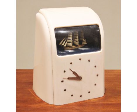 A 1940's Vitascope Industries Ltd pink Bakelite clock, with a sailing ship automaton above a 14cm dial, Vitascope paper label
