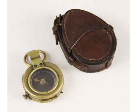 A cased WWI military brass bodied pocket compass, the base with broad arrow, serial number F-L No.124004 and date 1918, the l