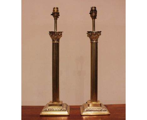 A pair of lacquered brass Corinthian column lamps, modern, each of typical fluted form upon an integrated plinth base, 48cm h