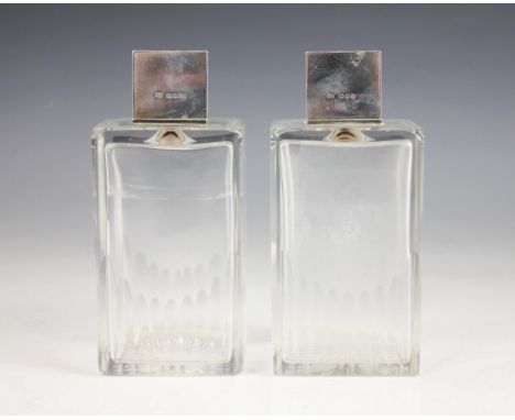 A pair of Art Deco cut glass silver mounted scent bottles, each colourless glass body of rectangular form with star cut base 