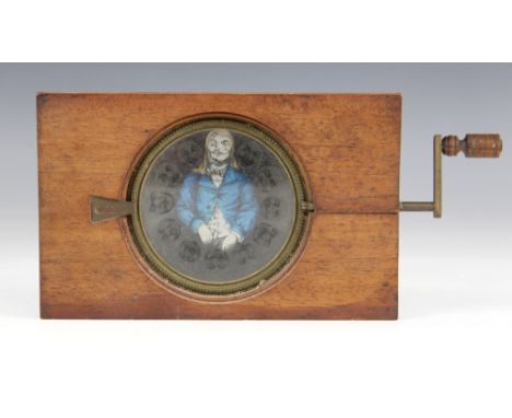 A Victorian mahogany-mounted hand painted rack and pinion magic lantern slide, late 19th century, the crank operated rotating