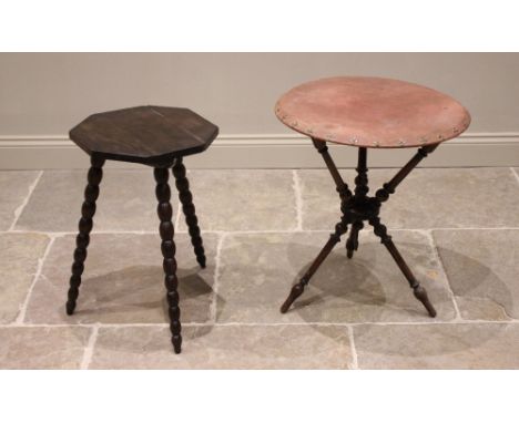 A Victorian mahogany gypsy table, the lined circular top punctuated with Maltese cross type studs, raised upon turned cylindr