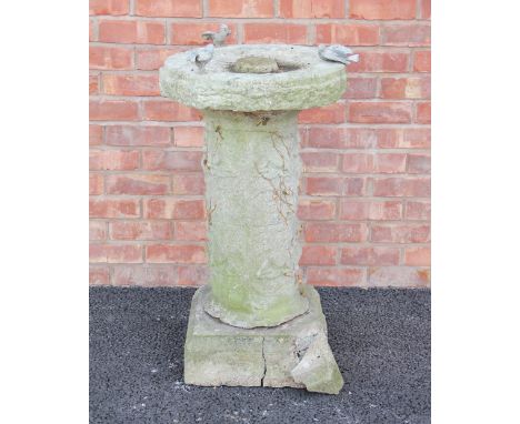 A reconstituted stone bird bath, the circular bath on a cylindrical pillar and square plinth base, 93cm high (at fault), alon