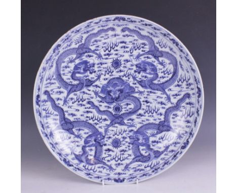 A large Chinese porcelain blue and white 'Dragon' charger, Kangxi mark, the shallow circular charger decorated with five drag