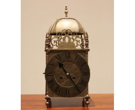 An 18th century style brass lantern clock, early 20th century, the four post case with 18cm dial applied with Roman numerals 