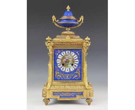 A late 19th century gilt metal and porcelain mantel clock by Pinchon Fils Aine, the case surmounted with a twin handled urn a