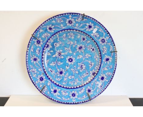 Large Iznic style ceramic Charger with Floral decoration on blue ground, 43cms diameter 