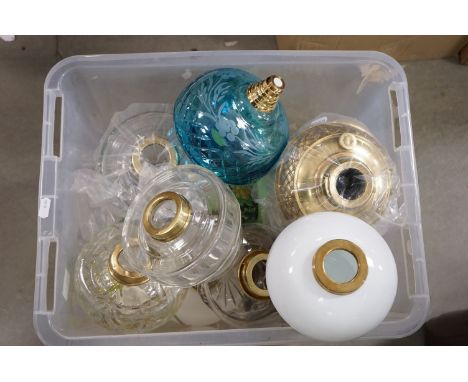 A large quantity of glass oil lamp wells together with a large quantity of burners etc. 