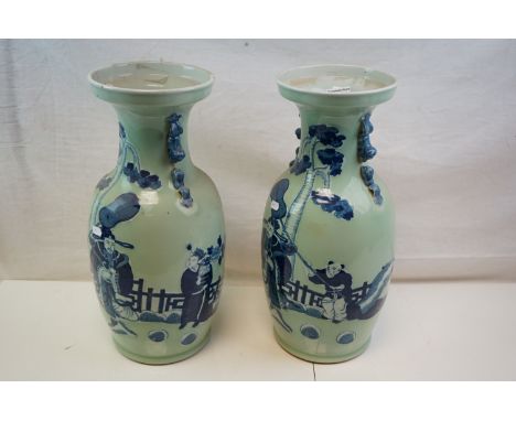 A large pair of ceramic oriental vases decorated with figures in a garden setting. 46 cm tall 