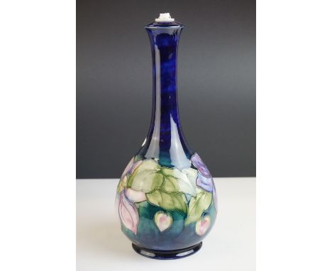 Moorcroft Lamp Base in the Clematis pattern on a blue ground, Moorcroft signature and impressed ' Moorcroft ' and ' Made in E