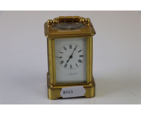 A brass cased miniature carriage clock with white enamel dial (A/F), marked hands to verso.