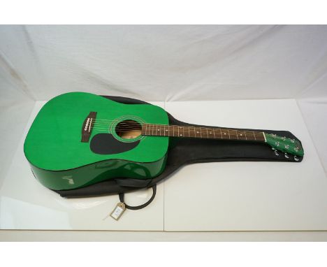 A green Stagg acoustic guitar and case. 