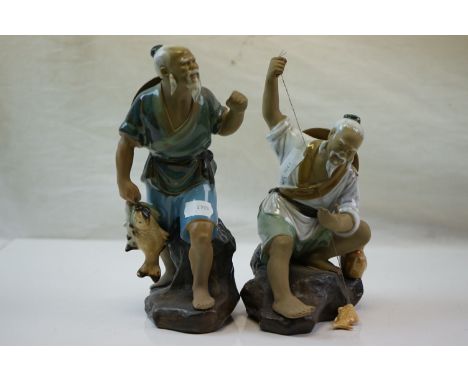 Two ceramic oriental figure of fisherman with catch. 